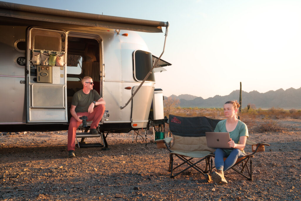 Jason + Debbie work on creating content for clients of Elemental Brand Photography outside the Airstream