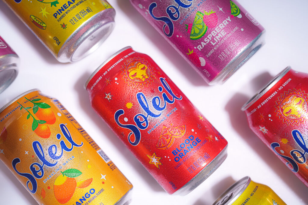 7 Ways a Brand Photoshoot Can Save You Time Creating Social Media Content 3 7 cans of Soleil laying on their sides on white background.