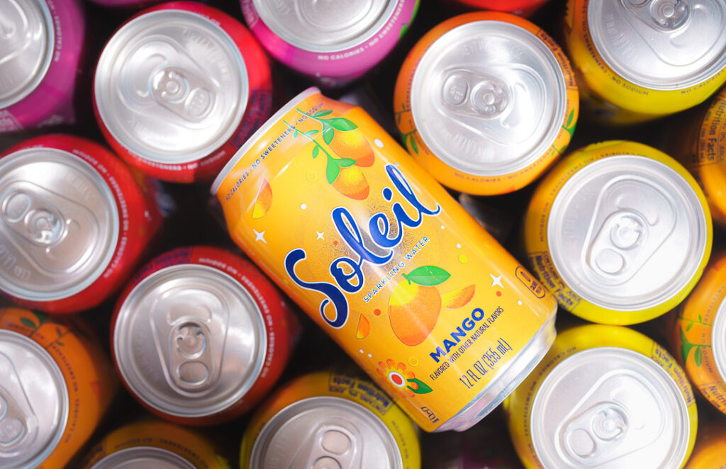 7 Ways a Brand Photoshoot Can Save You Time Creating Social Media Content 10 Top down look at a multicolored group of Soleil cans with center can label up.