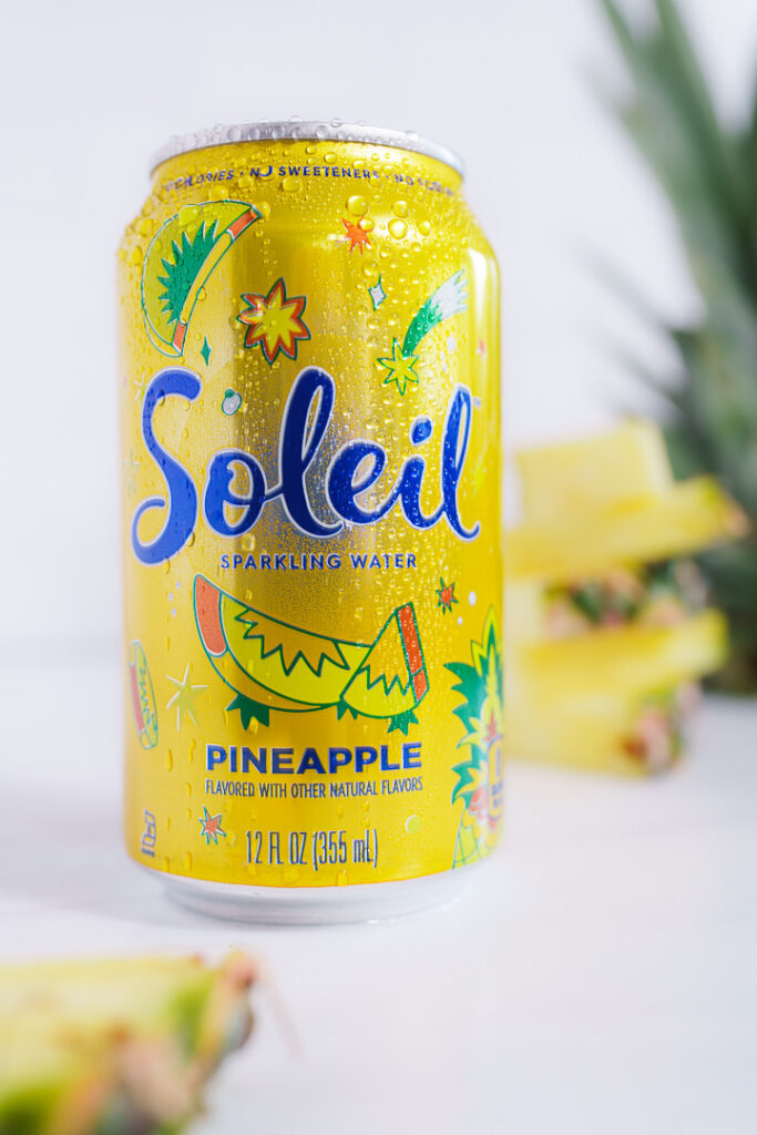 7 Ways a Brand Photoshoot Can Save You Time Creating Social Media Content 2 Yello can of Soleil with cut pineapple on white background