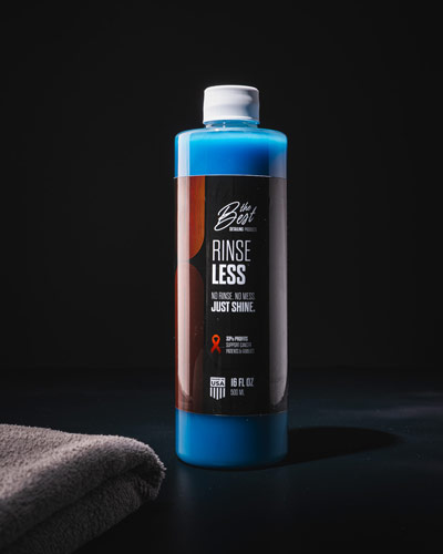 Bottle of Best Detailing Product Rineless auto detail sits with a microfiber towel