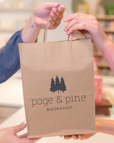 A customer takes a Page & Pine bag in a candid scene