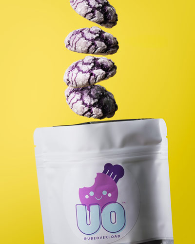 Ube Overload cookies fall into a Ube Overload branded bag