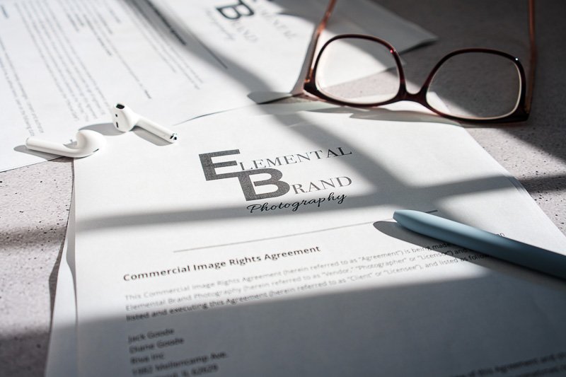 Seattle Brand Photography. Commercial photo license on desk setting with glasses and earbuds.