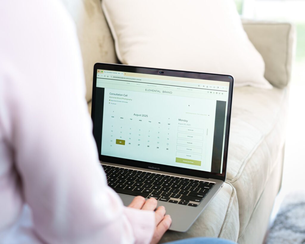 Seattle brand photography. Computer screen showing Elemental Brand Photography consultation/meeting calendar over a persons shoulder.