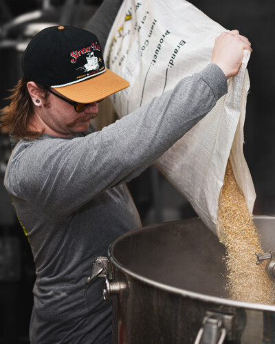 To highlight the brewmaster at work, the background was desaturated and made monochromatic, focusing attention on the craft, care, and expertise that go into every beer the brand produces. The brewmaster of North 47 adds grain to begin the brewing process