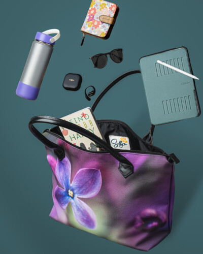 Showcase all the capabilities of a product by creating a visual representation of what it can do for you - like everything that you might find in a purse of this size A bag from Sally's Blooming Bags with multiple things that you would find being carried in that bag exploding out of the bag into the scene around it