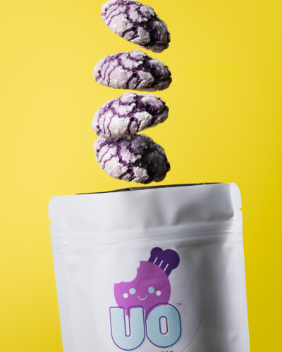 Using bright colors and intentional compositions, we created an image by compositing multiple cookie shots into one image, giving the impression they are falling out of the sky and into the packaging A stack of crinkle Ube cookies drop out of the air into the Ube Overload packaging
