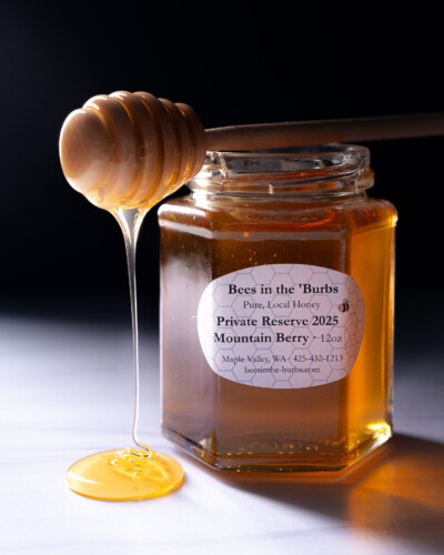 Showcasing the honey/product makes a more interesting photo and showcases the quality and beauty of the product Jar of Bees in the 'Burbs honey drips off honey dipper while sitting on a honey jar