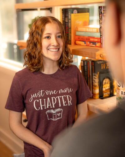Seattle brand photography for Branches Booknook inside House & Hazel in Maple Valley, WA. A browsing moment inside the intimate bookshop space with the friendly owners - lifestyle brand photography that captures the lingering warmth and welcoming nature of a Pacific Northwest independent bookshop. Seattle Brand Photography - Friendly and Welcoming Owner - Branches BookNook - Maple Valley - Elemental Brand Photography