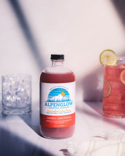 Seattle Product Photography for Alpenglow Cocktail Mixers in Issaquah, WA - natural afternoon light with window shadows and a sparkling refreshment made from Cherry Lime Punch - evergreen marketing content Seattle Product Photography - Cherry Lime Punch Cocktail Mixer - Alpenglow Cocktail Mixers Issaquah WA Elemental Brand Photography