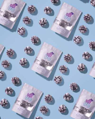 Seattle product photography for Ube Overload in Maple Valley, WA. Vibrant purple ube crinkle cookies and branded packaging arranged in a bold repeating pattern - scroll-stopping, eye-catching social media content for a Filipino-inspired Pacific Northwest artisan dessert brand. Seattle Product Photography - Ube Crinkle Cookie and Packaging Repeating Pattern Composition - Ube Overload Artisan Dessert Brand - Maple Valley, WA Elemental Brand Photography