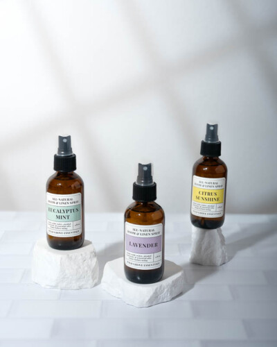 Seattle product photography for Wild Grove Essentials. Eucalyptus Mint, Lavender, and Citrus Sunshine room and linen sprays styled with window light and shadow on a tile counter - intentional lifestyle product photography for a Pacific Northwest wellness brand. Seattle Product Photography - Wild Grove Essentials Room and Linen Sprays with Window Shadow Depth on Tile Counter - Pacific Northwest - Maple Valley -Elemental Brand Photography