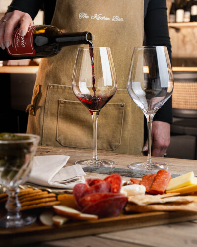 Seattle restaurant photography for House & Hazel in Maple Valley, WA. An elegant wine pour captured mid-action - beverage photography for a thoughtfully curated Pacific Northwest destination that blends interior design, dining, and local community. Seattle Restaurant Photography - House and Hazel Wine Pour in Maple Valley Restaurant and Bar - Pacific Northwest Dining Experience - Maple Valley, WA - Elemental Brand Photography