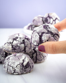 Seattle Product Photography for Ube Overload Bakery in Kent, WA. A product image showcasing a human interacting with the cakey, sugary ube crinkle cookies offered by Ube Overload Bakery in Kent, WA. Seattle Product Photography for Ube Overload in Kent, WA. A stylized product photo with a human element showcasing ube crinkle cookies offered at a local bakery from a viewers perspective. Elemental Brand Photography